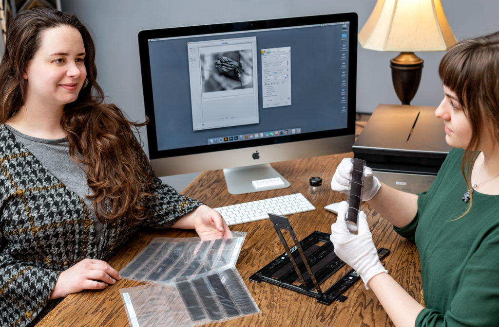 A woman has her film scanned at Petoskey Print Studio